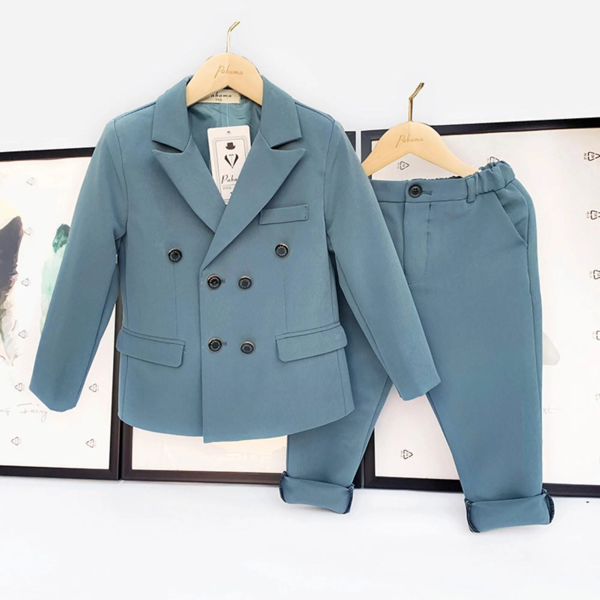 BabZ-baby boy dress clothes 0-3 months-Light blue double-breasted suit for baby boys, displayed on hangers.a blue suit and pants hanging on a wall